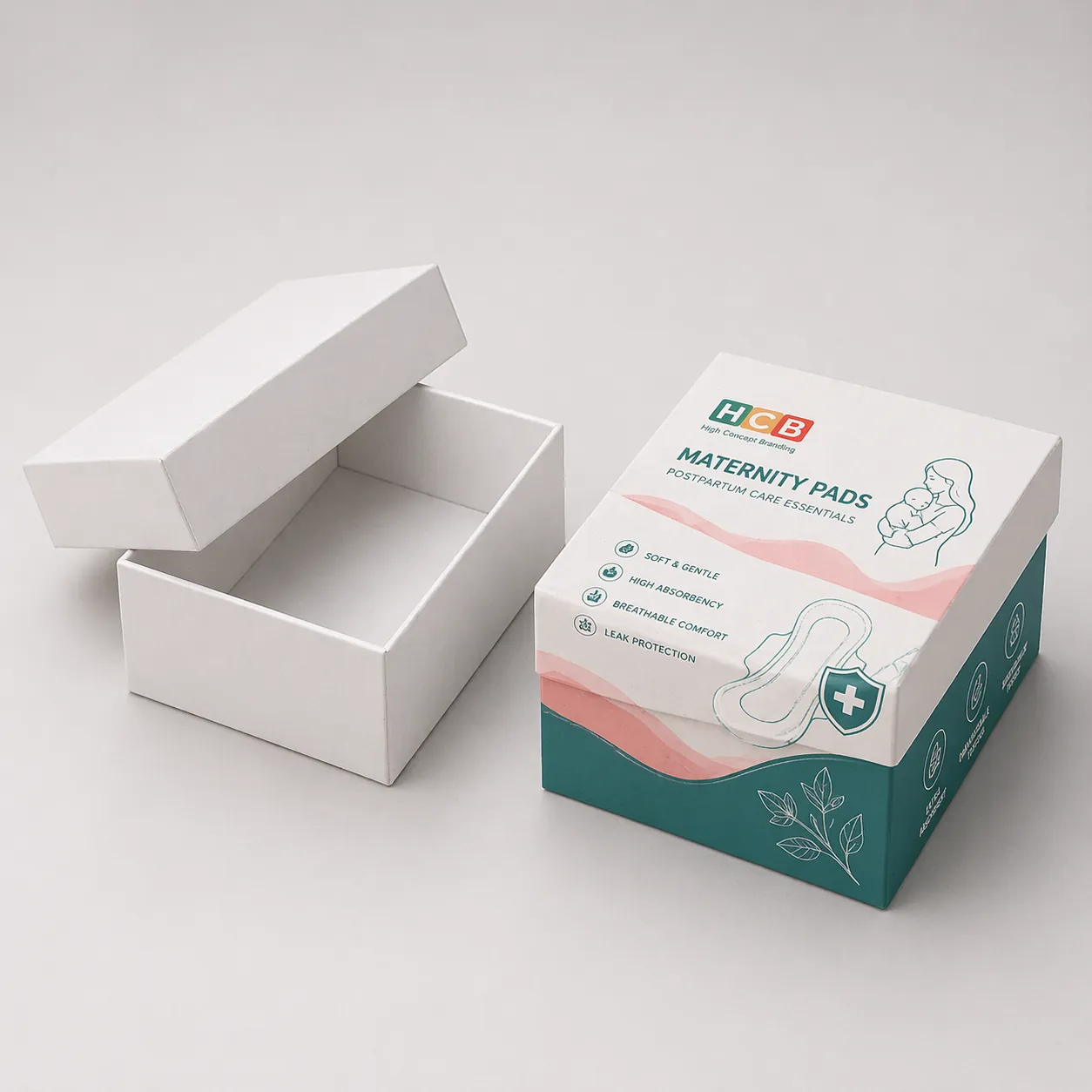 Two tall cardboard boxes, one blank and one decorated with pink flowers and brand information. class=